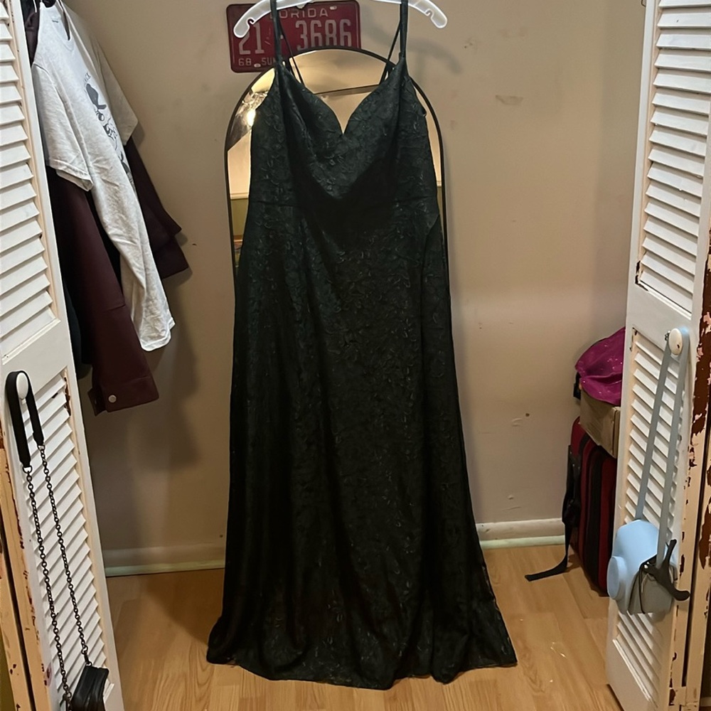 Dark green, long, flowing dress with flower design.